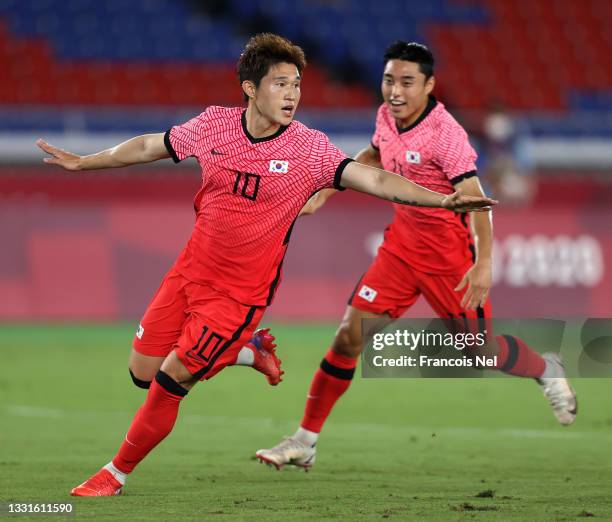 Donggyeong Lee of Team South Korea celebrates with teammate Dongjun Lee after scoring their side's first goal during the Men's Quarter Final match...