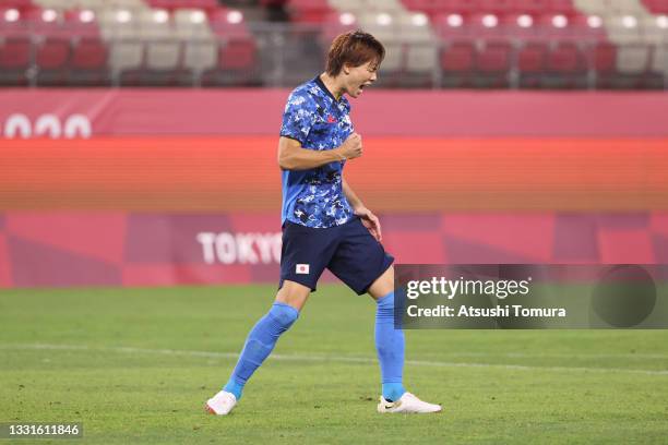 Kou Itakura of Team Japan celebrates scoring their team's second penalty in the penalty shoot out during the Men's Quarter Final match between Japan...