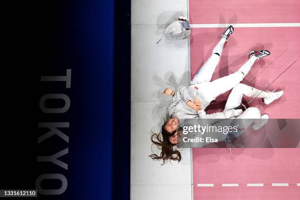 Olga Nikitina and Sofia Pozdniakova of team ROC celebrate after winning the Women's Sabre Team Fencing Gold Medal Match against Team France on day...