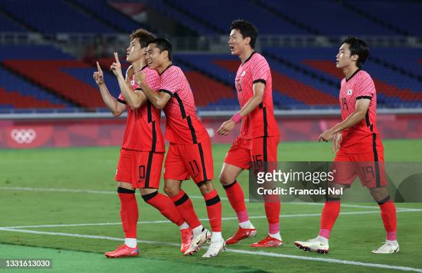 Donggyeong Lee of Team South Korea celebrates with teammates Dongjun Lee, Uijo Hwang and Yoonseong Kang after scoring their side's first goal during...