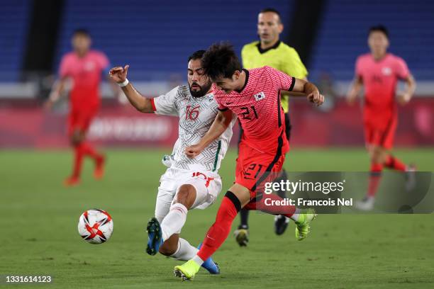 Jingyu Kim of Team South Korea crosses the ball whilst under pressure from Joaquin Esquivel of Team Mexico during the Men's Quarter Final match...