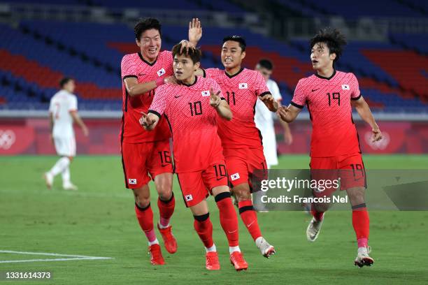 Donggyeong Lee of Team South Korea celebrates with teammates Uijo Hwang, Dongjun Lee and Yoonseong Kang after scoring their side's first goal during...