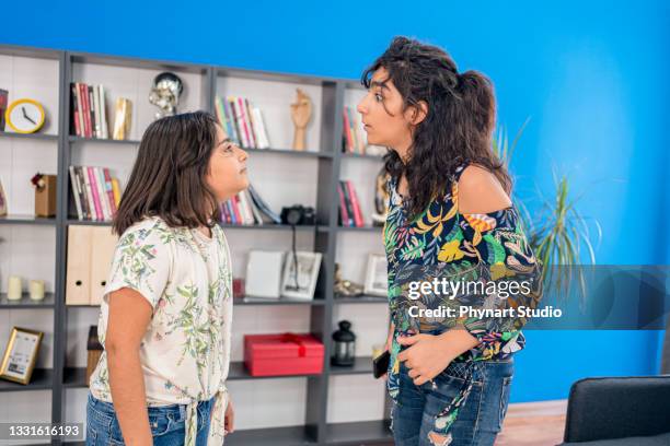 sisters arguing at home - sister stock pictures, royalty-free photos & images
