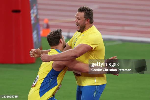 Daniel Stahl of Team Sweden celebrates with Simon Pettersson of Team Sweden after winning the Men's Discus Throw Final on day eight of the Tokyo 2020...