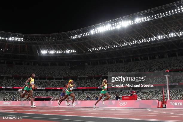 Elaine Thompson-Herah of Team Jamaica celebrates before crossing the finish line to win the gold medal in the Women's 100m Final on day eight of the...
