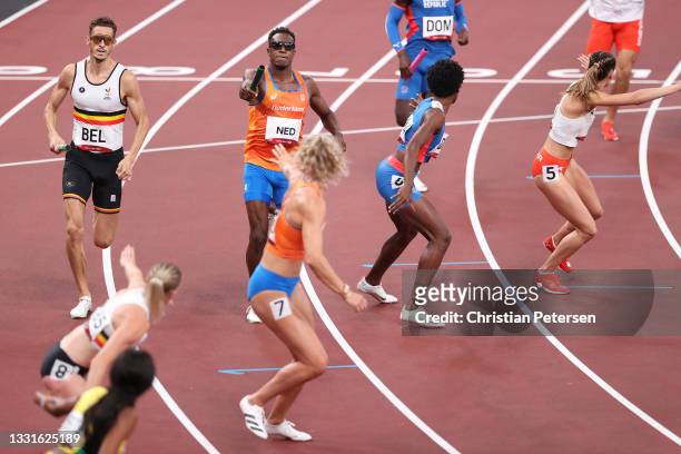 Runners pass their batons in the 4x400m Relay Mixed Final on day eight of the Tokyo 2020 Olympic Games at Olympic Stadium on July 31, 2021 in Tokyo,...