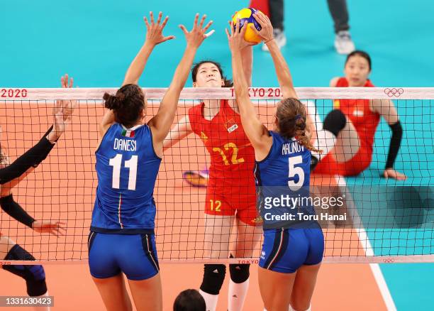 Yingying Li of Team China competes against Anna Danesi and Ofelia Malinov of Team Italy during the Women's Preliminary - Pool B volleyball on day...