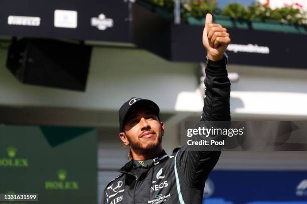 Pole position qualifier Lewis Hamilton of Great Britain and Mercedes GP celebrates in parc ferme during qualifying ahead of the F1 Grand Prix of...