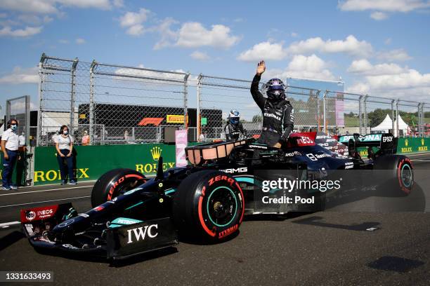 Pole position qualifier Lewis Hamilton of Great Britain and Mercedes GP celebrates in parc ferme during qualifying ahead of the F1 Grand Prix of...