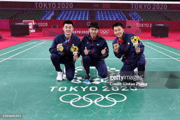 Gold medalists of Men’s Doubles badminton event Lee Yang and Wang Chi-Lin of Team Chinese Taipei pose for photo with their coach Chen Hung-ling on...