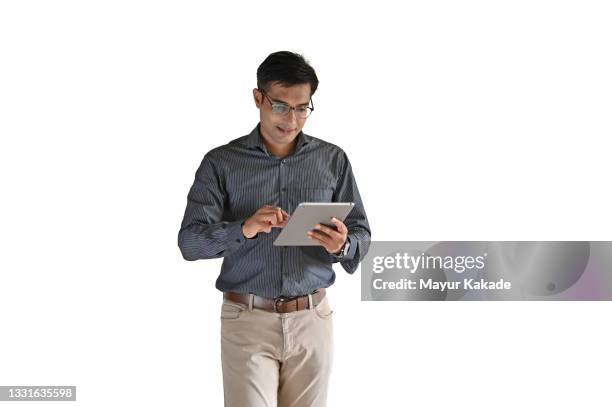 portrait of a mid age man using digital tablet against white background - india phone professional stock-fotos und bilder