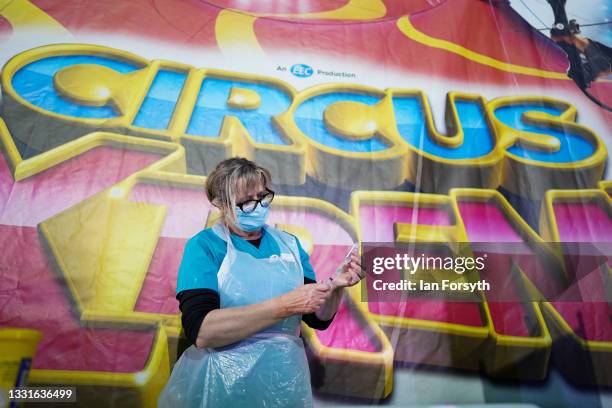 Dr Lisa Pickles draws up the Pfizer-BioNTech COVID-19 vaccine at a new ‘Pop Up’ vaccination centre in the Big Top of Circus Extreme in Shibden Park...
