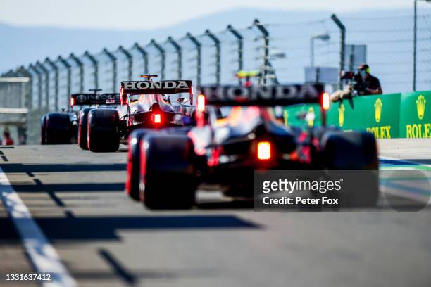 Lewis Hamilton of Mercedes and Great Britain leads Max Verstappen of Red Bull Racing and The Netherlands and Sergio Perez of Mexico and Red Bull...