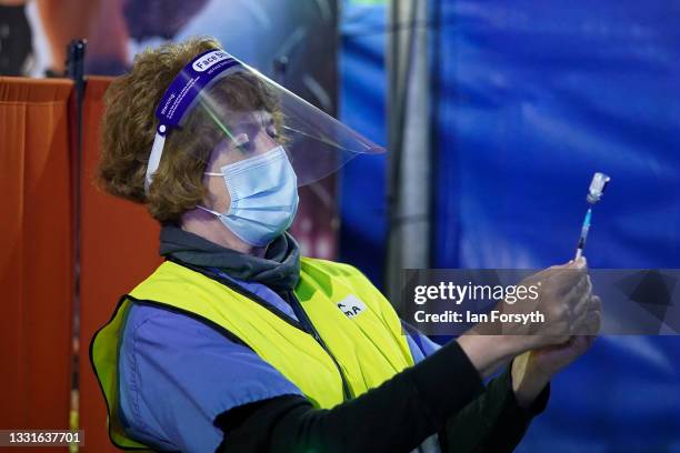 Member of the medical staff draws up the Pfizer-BioNTech COVID-19 vaccine at a new ‘Pop Up’ vaccination centre in the Big Top of Circus Extreme in...