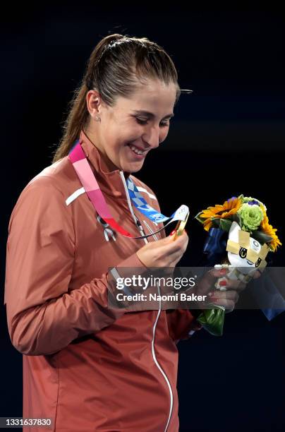 Belinda Bencic of Team Switzerland looks at her gold medal during the medal ceremony after the Women's Singles Gold Medal match on day eight of the...