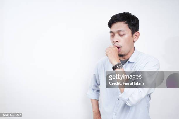 asian young men is coughing as a covid symptoms - three quarter front view ストックフォトと画像