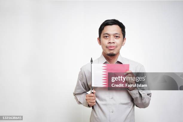 asian man holding qatari flag - indonesia independence stock pictures, royalty-free photos & images