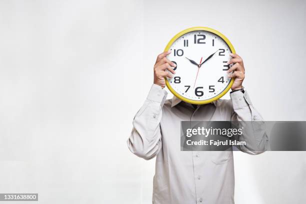 covering head with wall clock - time blocking stock pictures, royalty-free photos & images