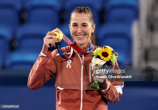 Belinda Bencic of Team Switzerland smiles with her gold medal from the podium during the medal ceremony after defeating Marketa Vondrousova of Team...