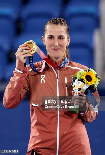 Belinda Bencic of Team Switzerland smiles with her gold medal from the podium during the medal ceremony after defeating Marketa Vondrousova of Team...