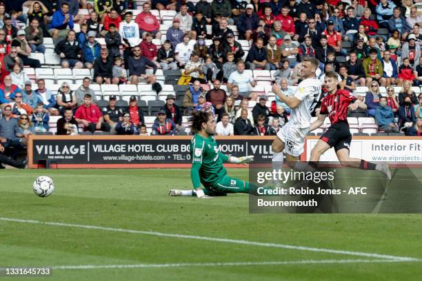 David Brooks of Bournemouth beats keeper Franco Ravizzoli of MK Dons and scores a goal to make it 5-0 during the Carabao Cup 1st Round match between...