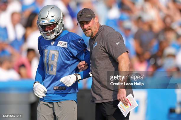 Geronimo Allison of the Detroit Lions talks with head coach Dan Campbell during Training Camp on July 31, 2021 in Allen Park, Michigan.