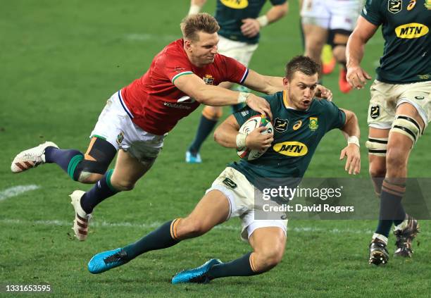 Handre Pollard of South Africa Springboks is tackled by Dan Bigger of British & Irish Lions during the 2nd Test between South Africa Springboks and...