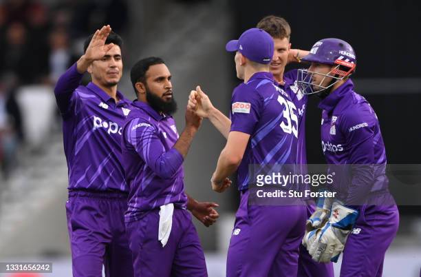 Superchargers bowler Adil Rashid is congratulated after taking the wicket of Laurie Evans during The Hundred match between Northern Superchargers Men...