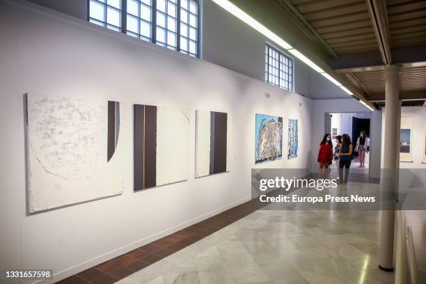 Attendees look at the works that make up the exhibition 'Catorce relatos breves', at the Casa de Vacas Cultural Center, on July 29 in Madrid, Spain....