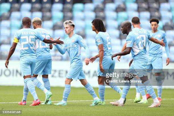 Ben Knight of Manchester City celebrates with Fernandinho and team mates after scoring their side's second goal during the Pre-Season Friendly match...
