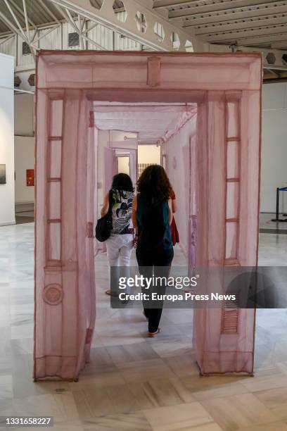 Attendees look at the works that make up the exhibition 'Catorce relatos breves', at the Casa de Vacas Cultural Center, on July 29 in Madrid, Spain....