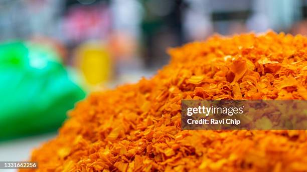 cut flowers stacked into a heap for making pookalam during onam festival season - pookalam stock pictures, royalty-free photos & images