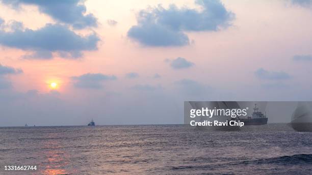 cargo ship sailing towards horizon - kochi stock pictures, royalty-free photos & images