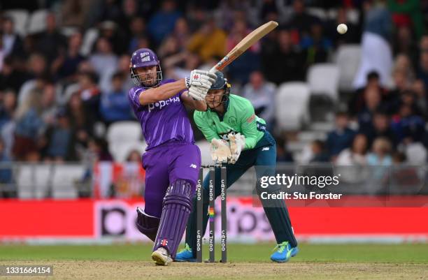 Superchargers batter Chris Lynn hits out watched by Sam Billings during The Hundred match between Northern Superchargers Men and Oval Invincibles Men...