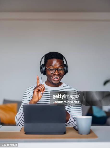 smiling businessman talking on video conference - ipad vertical stock pictures, royalty-free photos & images