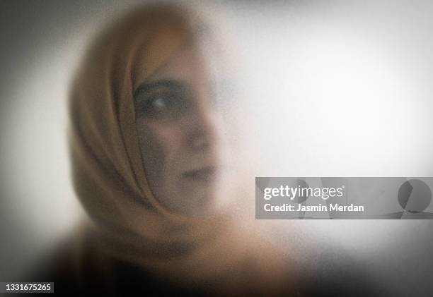 woman with hijab stuck in shadow - arab woman silhouette stock pictures, royalty-free photos & images