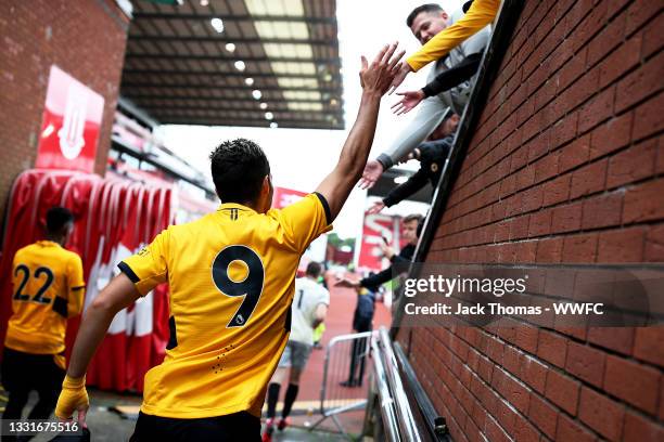 Raul Jimenez of Wolverhampton Wanderers high fives fans as he walks out following half time during the Pre-Season Friendly between Stoke City and...