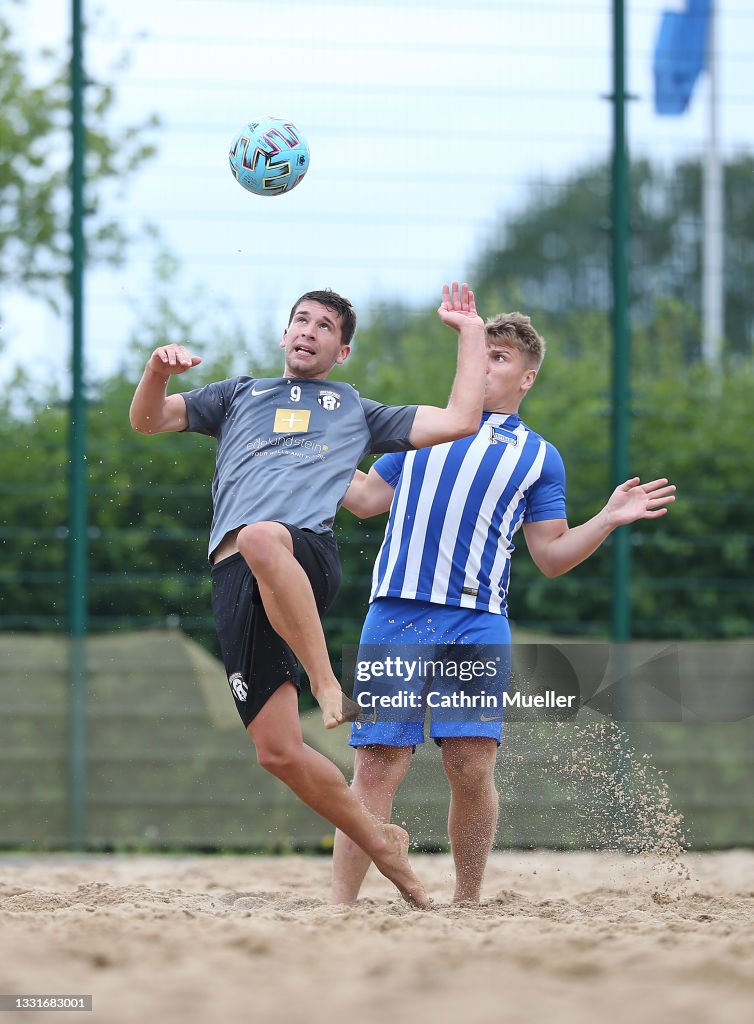 Tom Falk Marcel Nowak of Ibbenbuerener BSC is challenged by Tom Falk of Hertha ...
