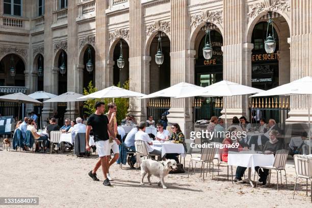 charming cafe terrace in paris (palais royal) - brasserie stockfoto's en -beelden