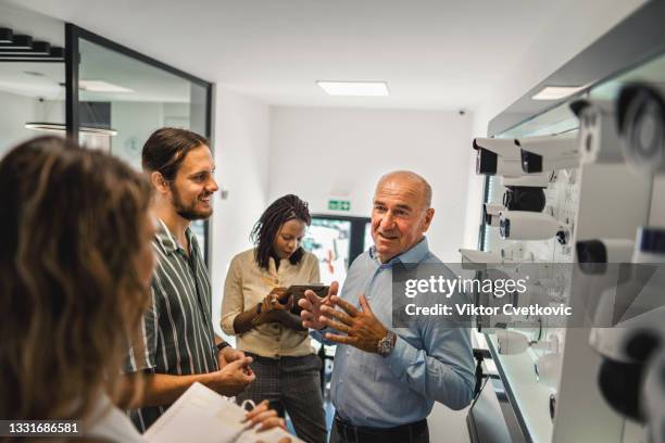 business presentation of security cameras in showroom - business security camera stock pictures, royalty-free photos & images