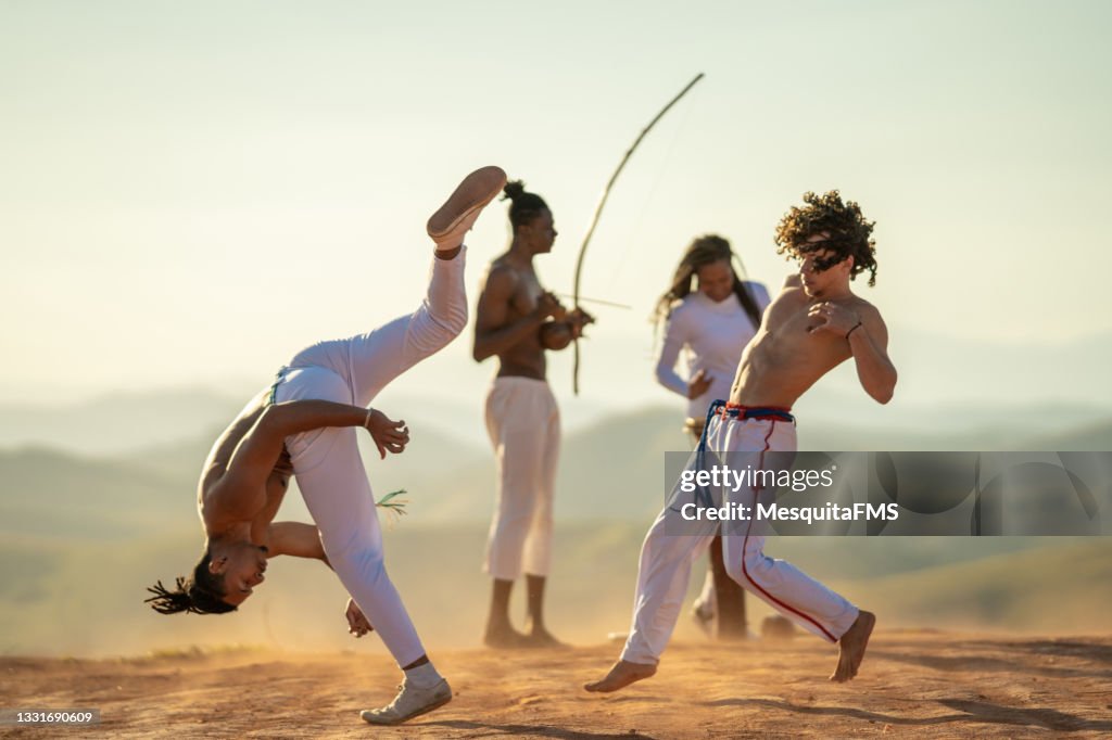 Capoeira fighters kicking