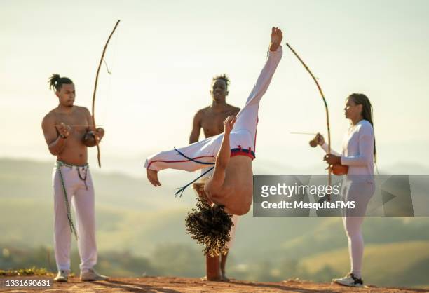 capoeira fighters kicking - berimbau stock pictures, royalty-free photos & images