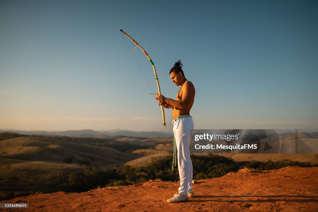 Capoeira man playing berimbau