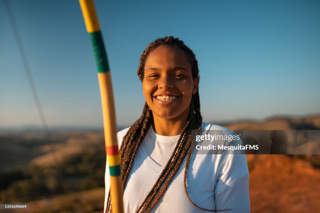 Capoeira woman playing berimbau