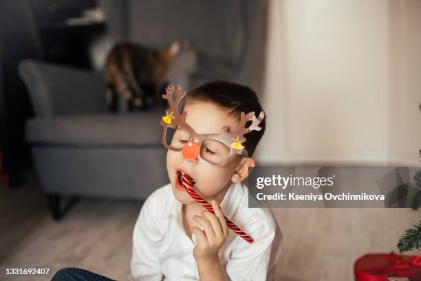 little child taking chocolate opening first day in handmade advent calendar made from toilet paper rolls. sustainable christmas, upcycling, zero waste, kids seasonal activities - child with advent calendar stock pictures, royalty-free photos & images