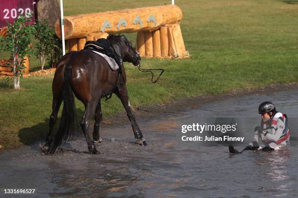 Arinadtha Chavatanont of Team Thailand riding Boleybawn Prince reacts after falling on day nine of the Tokyo 2020 Olympic Games at Sea Forest...