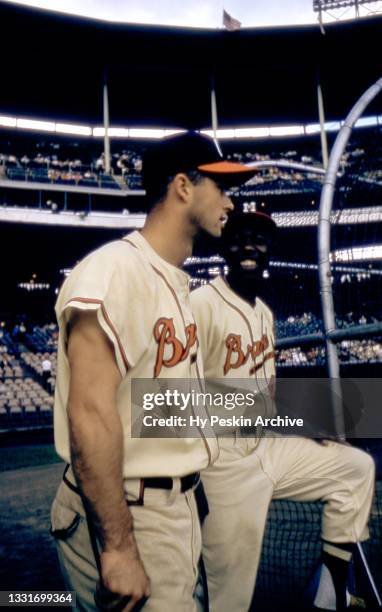 Hank Aaron and Eddie Mathews of the Milwaukee Braves wait their turn to hit in the cage during batting practice before an MLB game against the St....