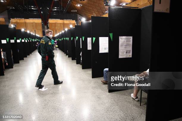 Staff work to vaccinate and check people at Vodafone Events Centre on August 01, 2021 in Auckland, New Zealand. New Zealand’s first mass Covid-19...