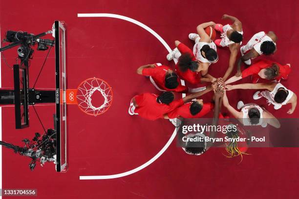 Members of Team Canada huddle before the start of the second half of a Women's Basketball Preliminary Round Group A game against Spain at Saitama...