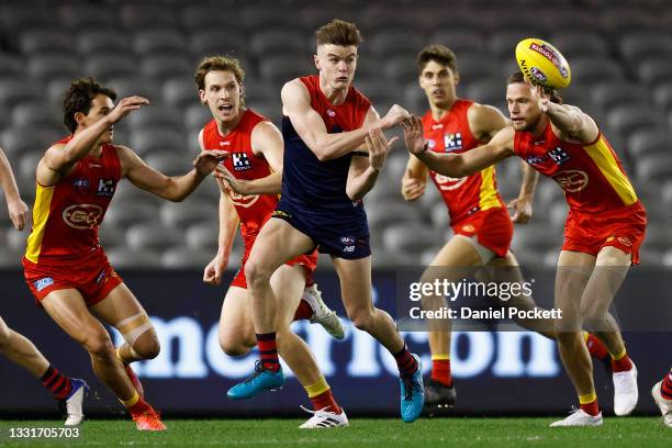 Bayley Fritsch of the Demons handballs during the round 20 AFL match between Gold Coast Suns and Melbourne Demons at Marvel Stadium on August 01,...